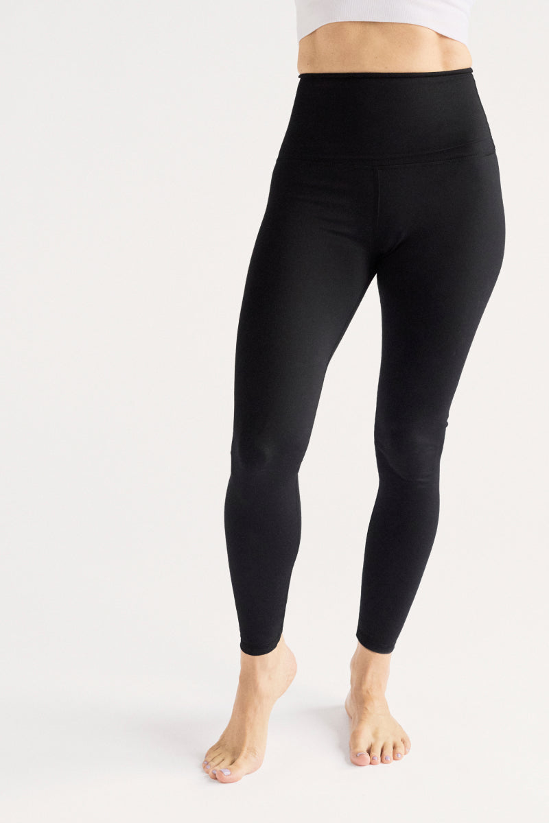 Black leggings worn by a person on a white background